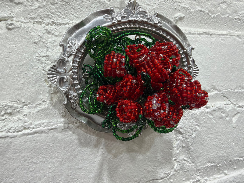 silver oval with a dozen roses