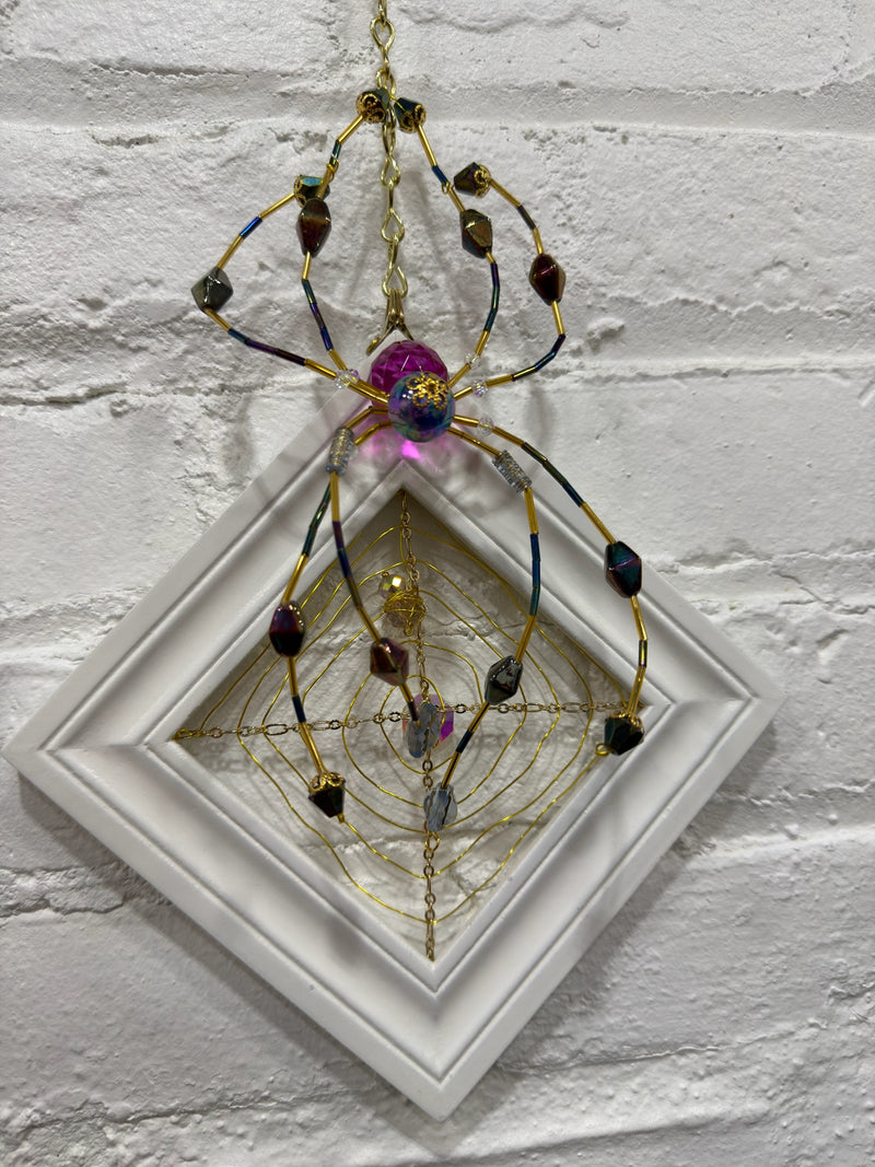 white square with purple spider