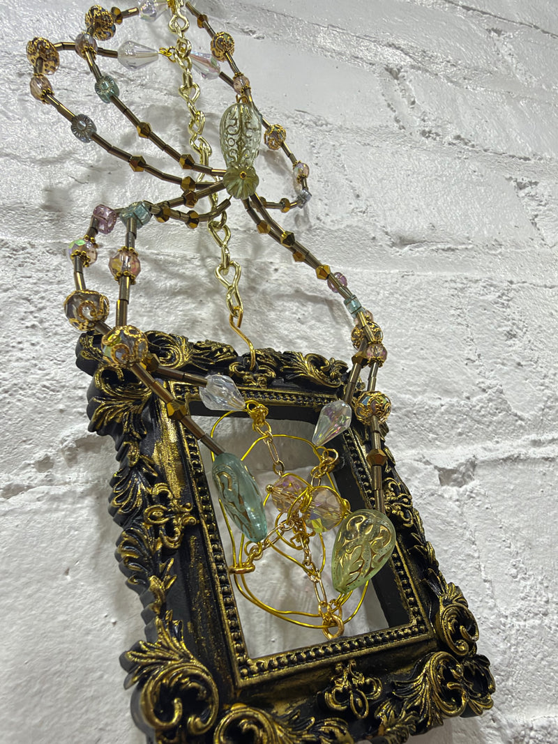 black square frame with green spider