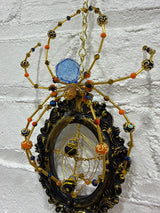 Black oval frame with gold Knicks Spider