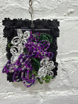 black square with purple and white flowers