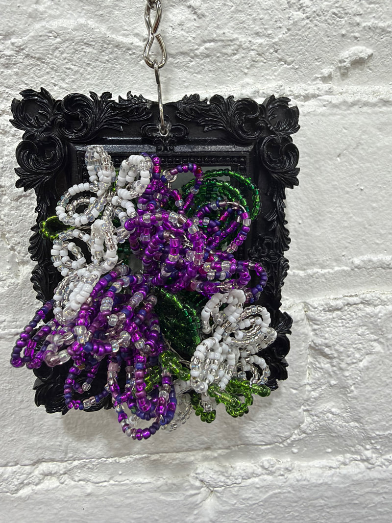 black square with purple and white flowers