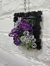 black square with purple and white flowers