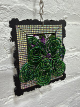 black square with purple and white flowers