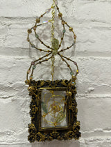 black square frame with green spider