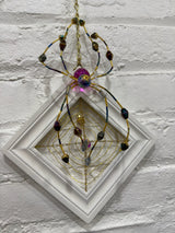white square with purple spider