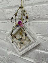 white square with purple spider