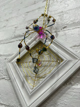 white square with purple spider