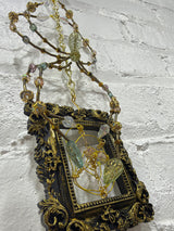 black square frame with green spider