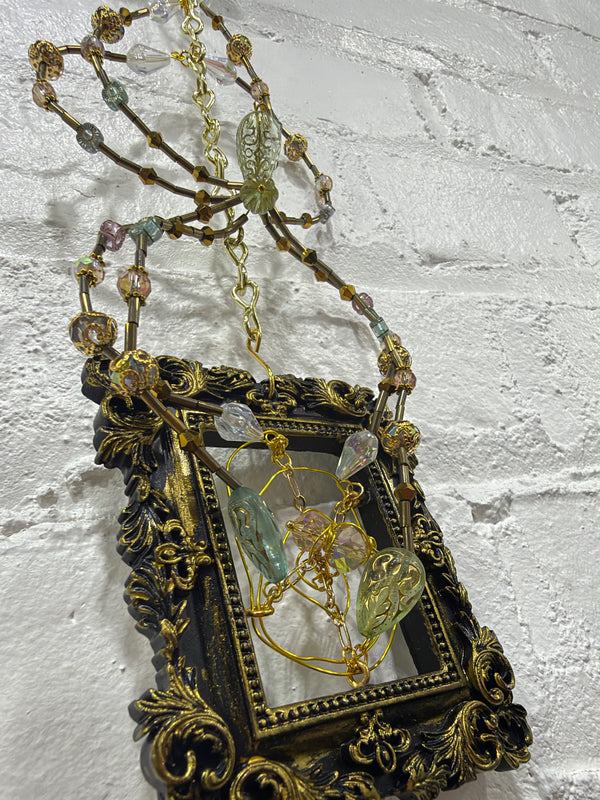 black square frame with green spider